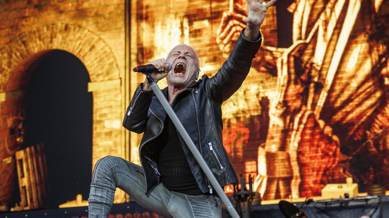Bruce Dickinson of Iron Maiden singing on stage.