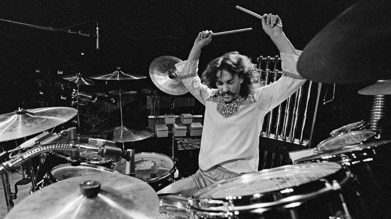 Neil Peart playing drums on stage