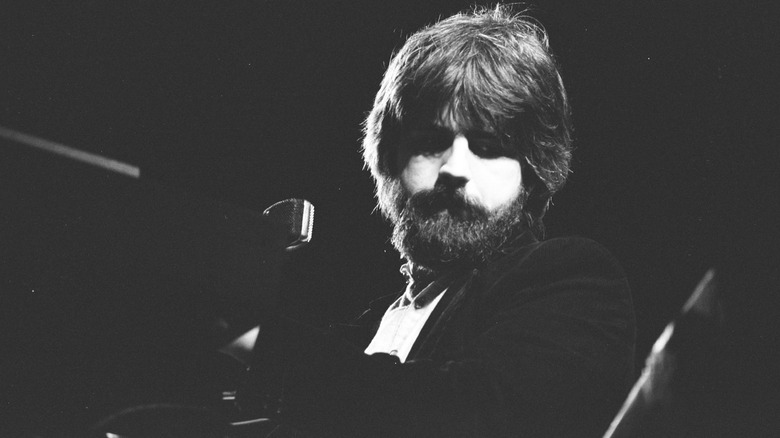 Bearded Michael McDonald of the Doobie Brothers performing piano on stage