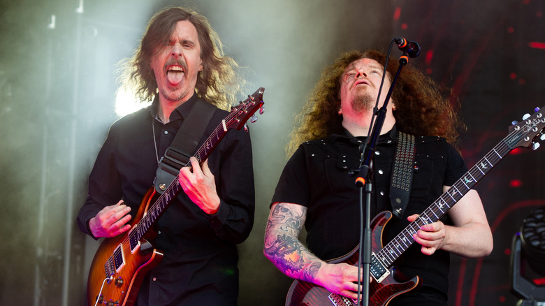 Members of Opeth playing guitars on stage