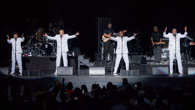 The Spinners performing onstage in 2024