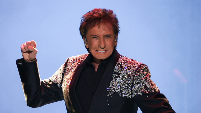 Barry Manilow onstage with fist raised