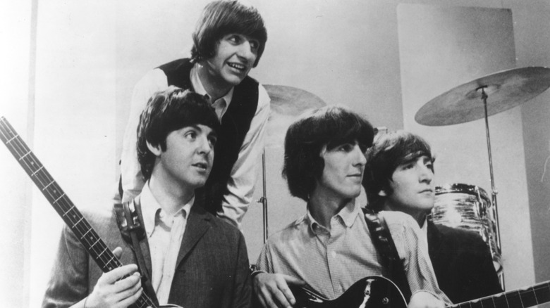 The Beatles posing with instruments