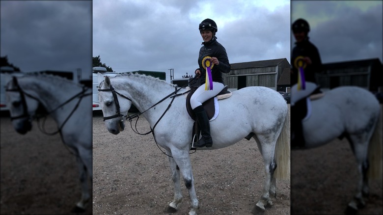 Jessica Whalley on a horse with rosette