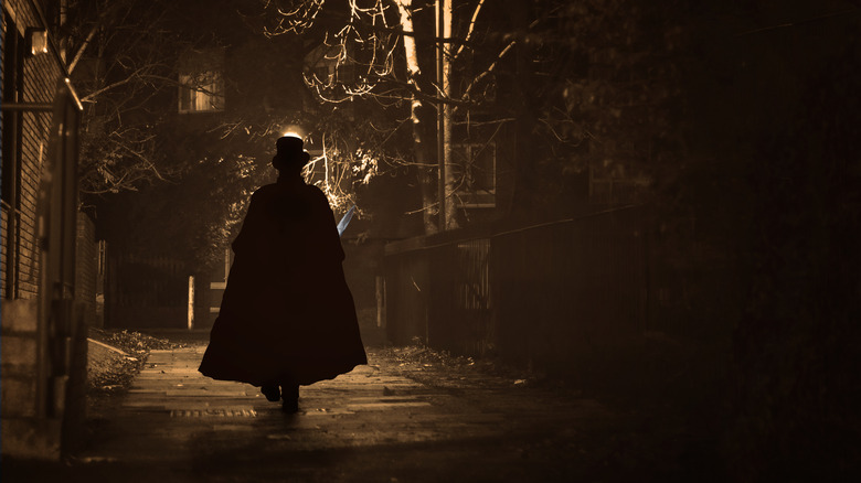 silhouette of man walking in the dark