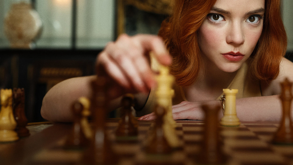 Anya Taylor with chess piece in "The Queen's Gambit"