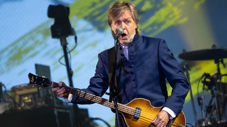 Paul McCartney performing on stage