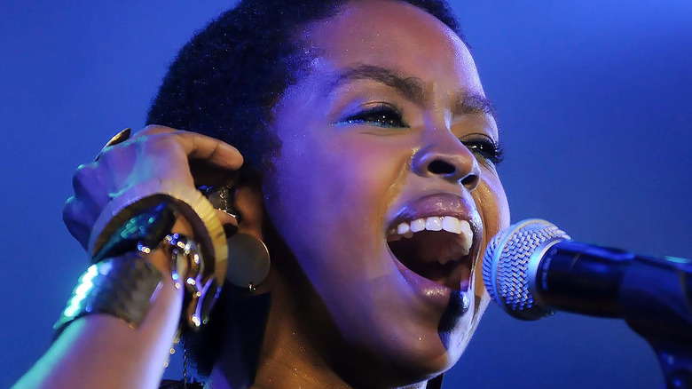 Lauryn Hill singing into microphone