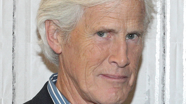 Keith Morrison looking at camera smirking curtain background