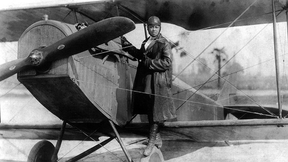 Bessie Coleman with her plane