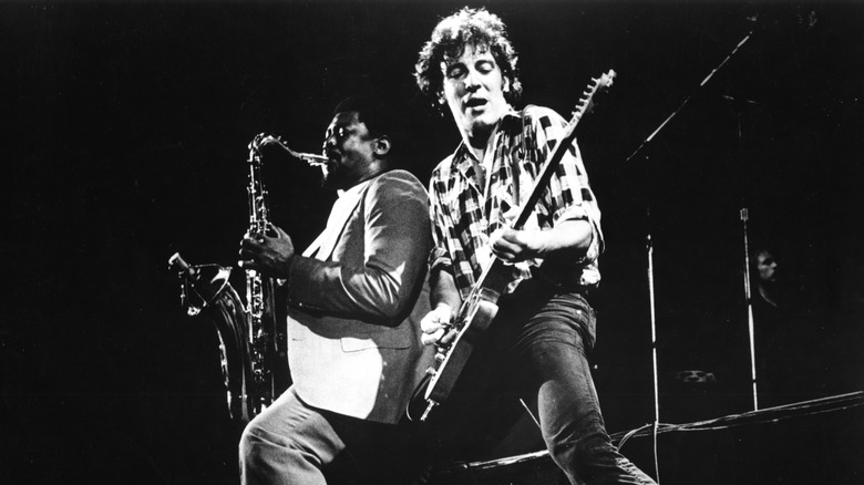 Clarence Clemons plays saxophone beside Bruce Springsteen playing guitar