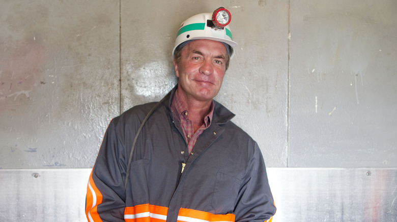 Chris Cline smiling in a mining helmet