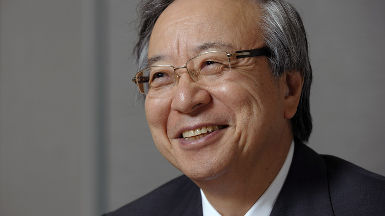 Masatoshi Ito smiling in glasses
