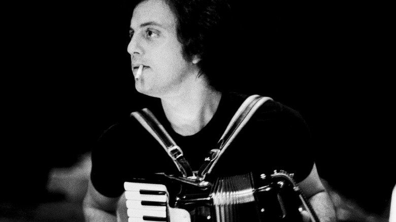 Billy Joel smoking and playing the accordion 