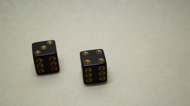 Two black and gold dice on a white background