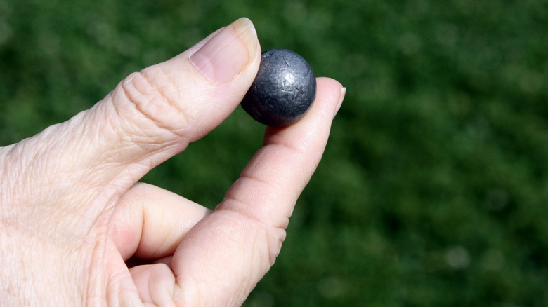 Hand holding a replca musket ball from Valley Forge