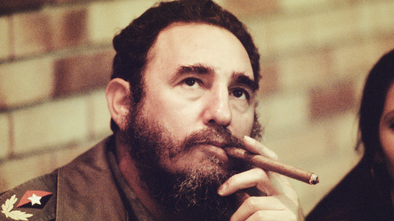 castro smoking a cigar in his office