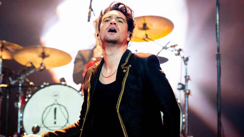 Brendon Urie performing on stage with Panic! At the Disco in 2023
