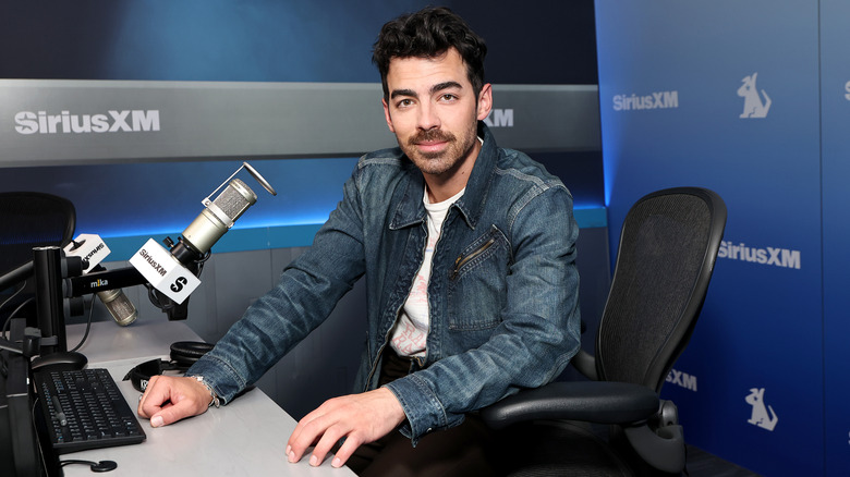 Joe Jonas sitting in a SiriusXM studio in 2025