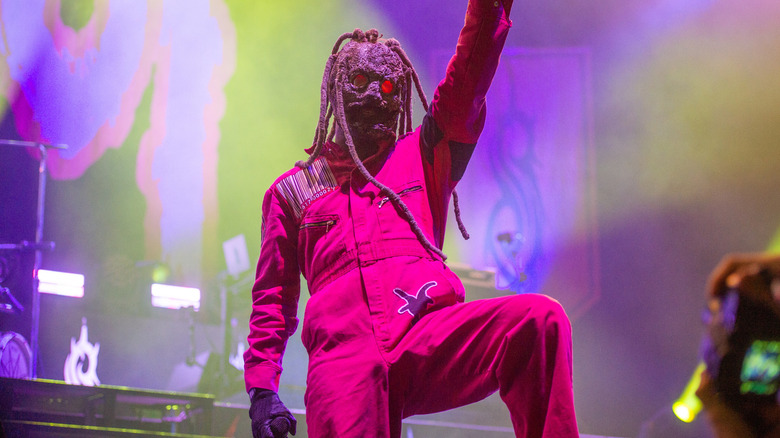Slipknot's Corey Taylor pointing during a concert in 2024