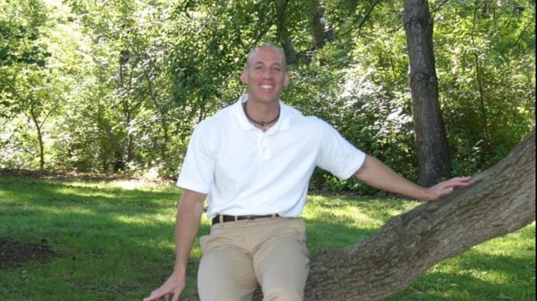 Aeryn Gillern sitting in a tree and smiling