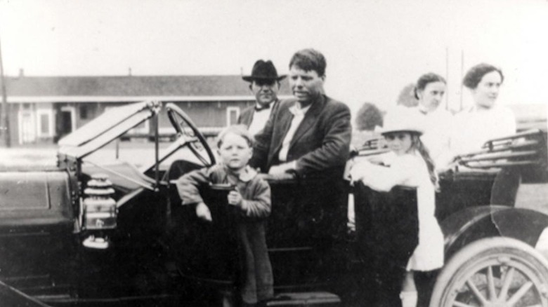 bobby dunbar with car and crowd of unidentified people ca. 1913