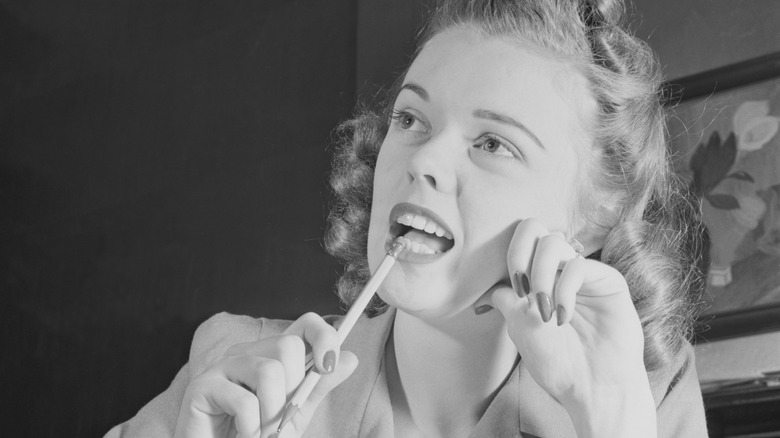 woman thinking and chewing pencil