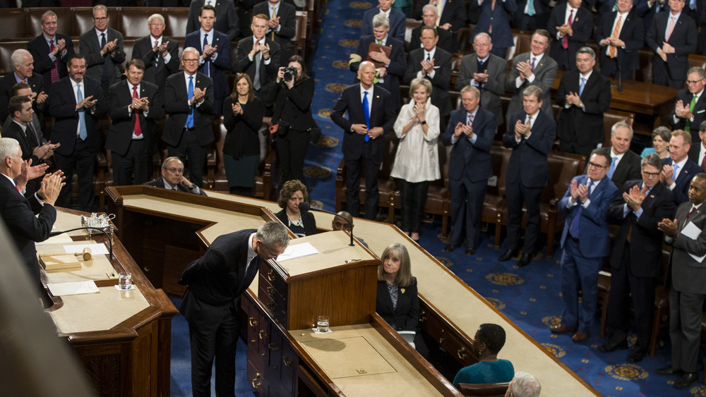 joint session of congress with people standing 