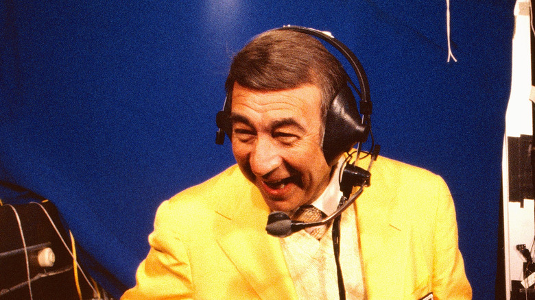 Howard Cosell wearing an announcer's headset