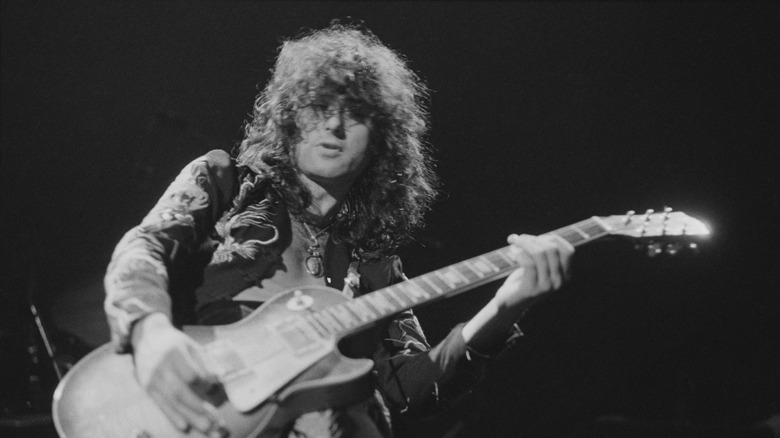 Jimmy Page playing guitar on stage