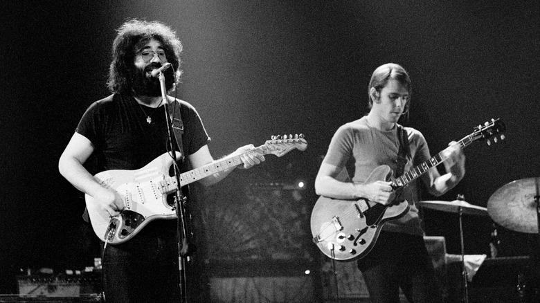 Black and white photo of Jerry Garcia performing with Bob Weir