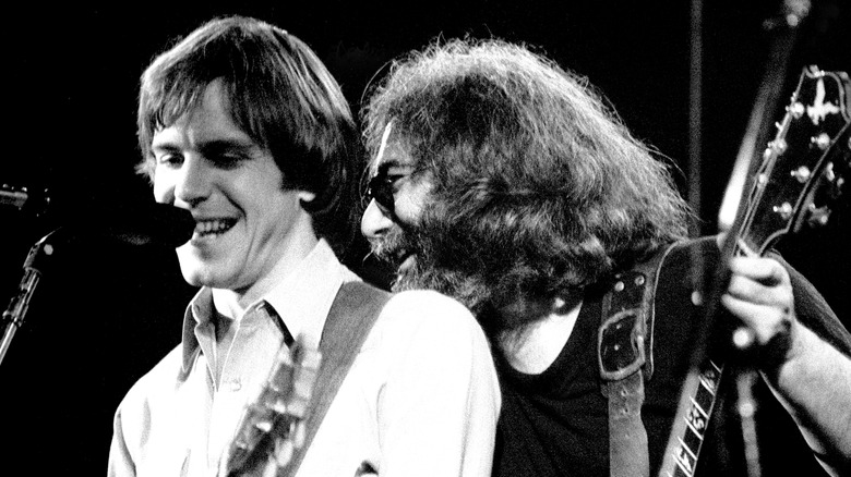 Black and white photo of Bob Weir performing with Jerry Garcia