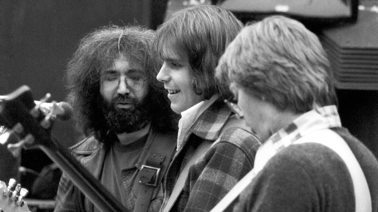 Jerry Garcia watching Bob Weir play guitar