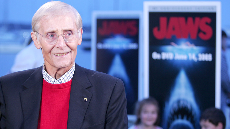 Peter Benchley smiling next to Jaws book