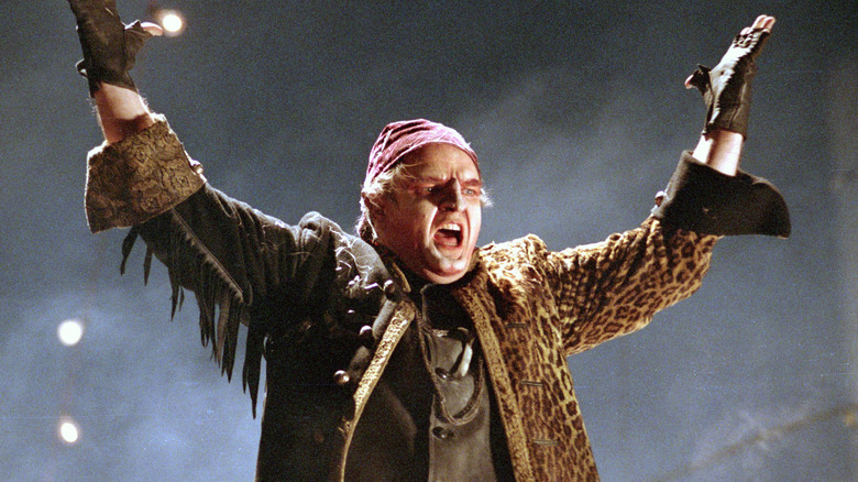 Meat Loaf singing with hands raised in 1993 video