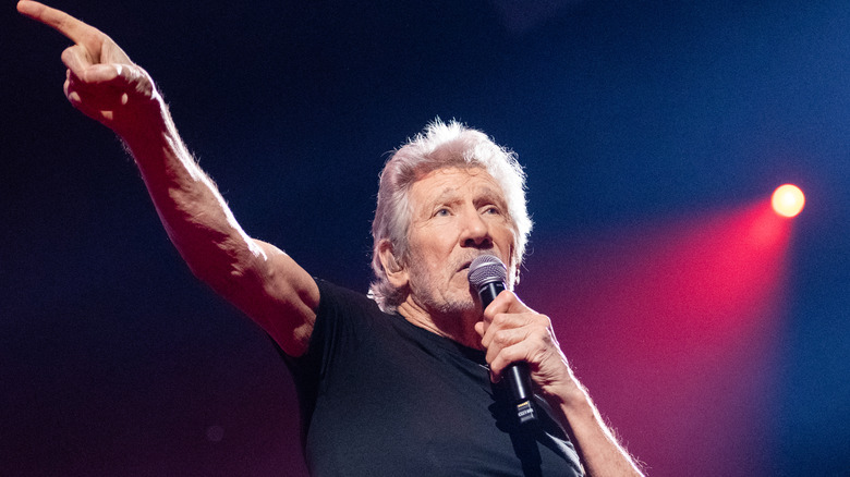 Roger Waters speaking into mic on stage