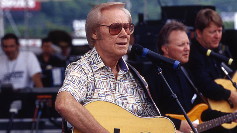 George Jones singing and playing guitar