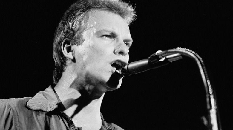 Sting singing at microphone