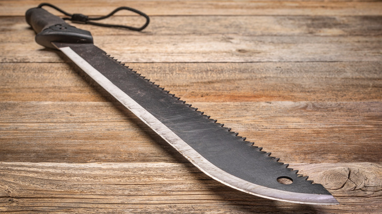 machete lying on wood surface