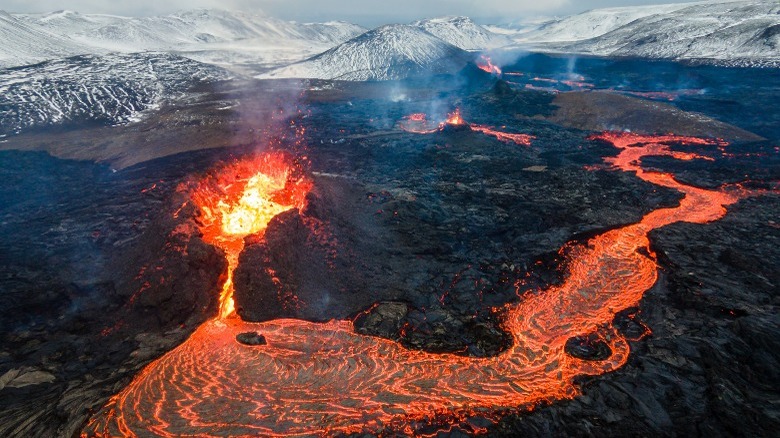 erupting volcano lava flow mountains