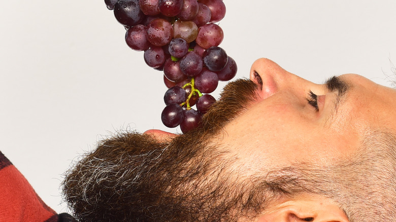 Man eating grapes