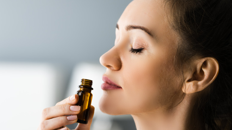 woman smelling bottle