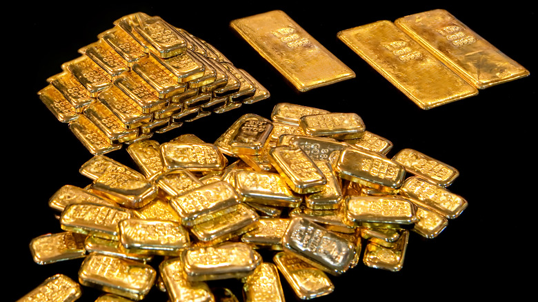 stacks of gold bars on a black background