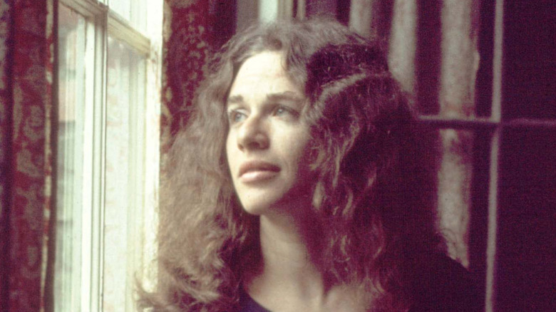 Carole King looking out window in Tapestry photo shoot