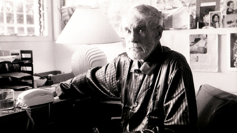 Timothy Leary at a desk in pajamas
