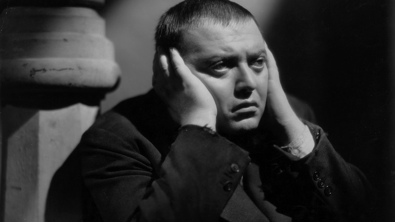 Peter Lorre suit hands over ears