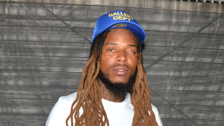fetty wap looking into camera wearing blue baseball cap