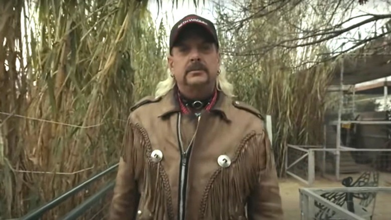 Joe Exotic in front of cages