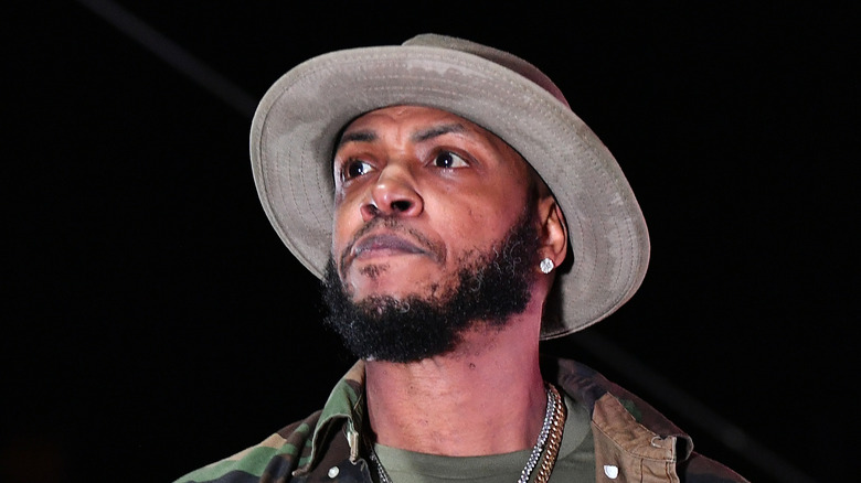 mystikal wears big hat and purses lips while looking out