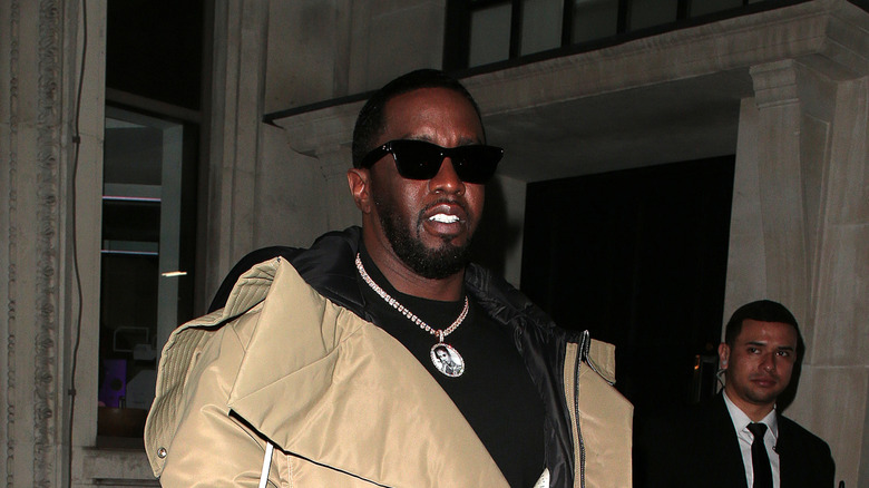 sean combs wearing sunglasses and big coat